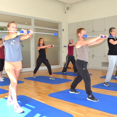 Mehrere Personen machen zusammen Gymnastikübungen.